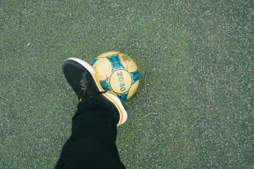 soccer player balances ball on foot outdoors